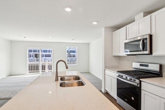 6335 Ulster Dr, Tinley Park, IL 60477 - kitchen featuring appliances with stainless steel finishes, a sink, light stone countertops, white cabinets, and recessed lighting