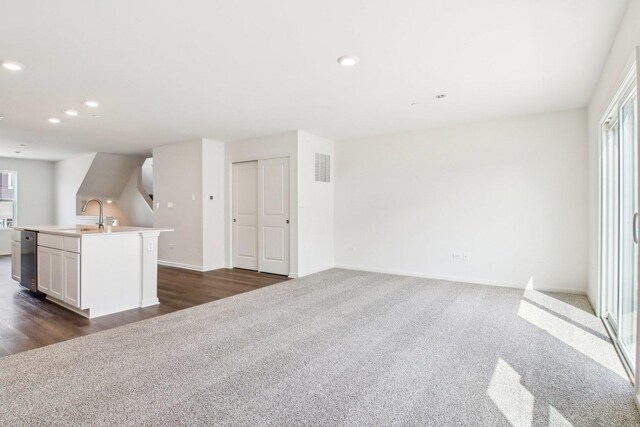 6335 Ulster Dr, Tinley Park, IL 60477 - unfurnished living room with dark carpet, a sink, recessed lighting, and baseboards