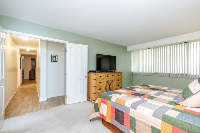 carpeted bedroom with baseboards