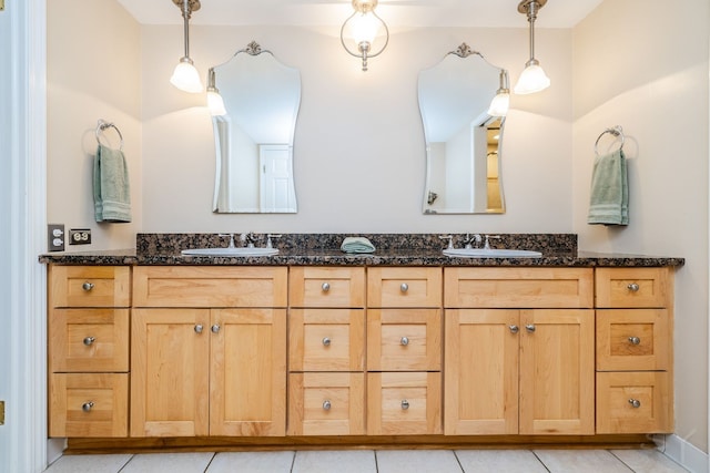 bathroom with double vanity and tile patterned floors