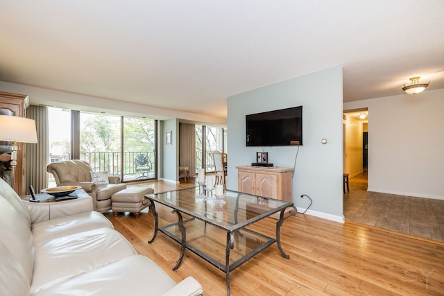 living room featuring light wood-type flooring and baseboards