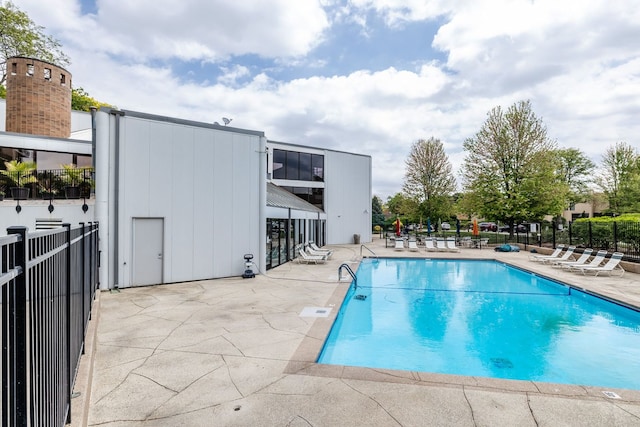 community pool featuring a patio and fence