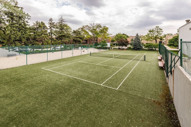 view of tennis court featuring fence