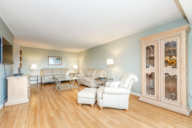 living room featuring light wood-type flooring and baseboards