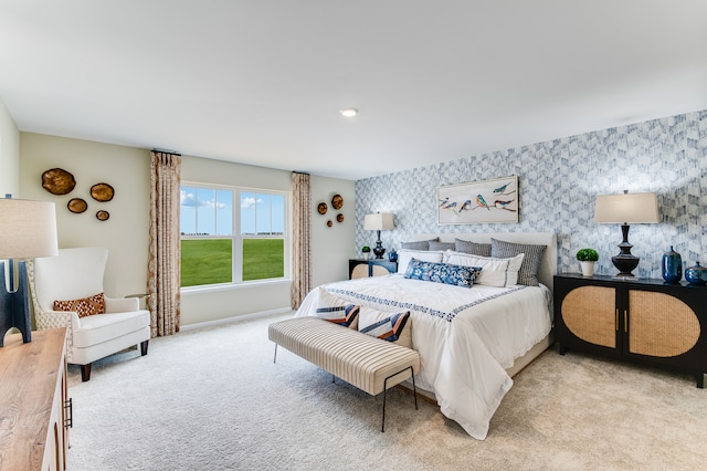 bedroom featuring wallpapered walls, light carpet, and baseboards