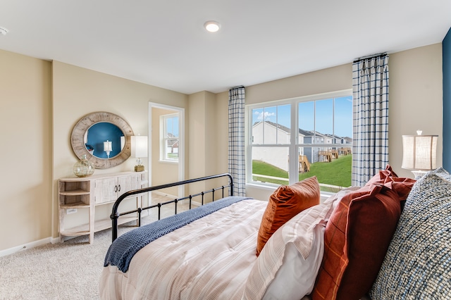 bedroom featuring carpet flooring and baseboards