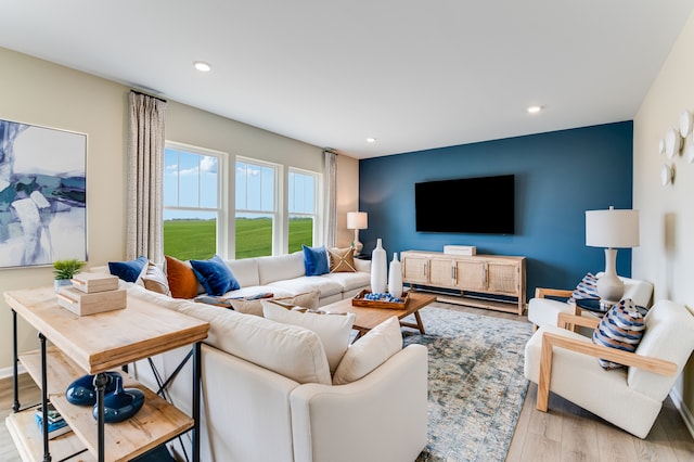 living room featuring light wood-style flooring and recessed lighting