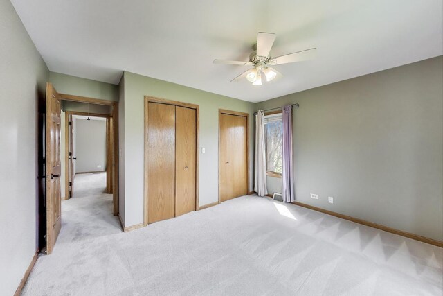 23883 W Sarah Ct, Antioch, IL 60002 - unfurnished bedroom featuring multiple closets, light colored carpet, baseboards, and ceiling fan