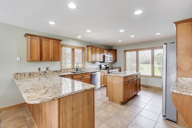 23883 W Sarah Ct, Antioch, IL 60002 - kitchen with appliances with stainless steel finishes, a sink, a peninsula, plenty of natural light, and recessed lighting
