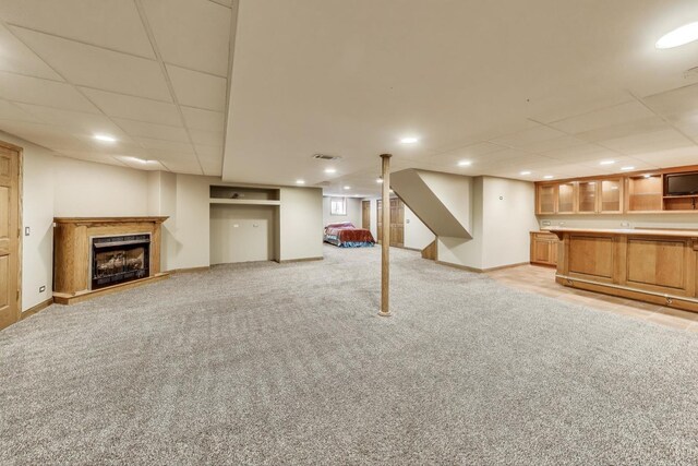 23883 W Sarah Ct, Antioch, IL 60002 - finished basement with light carpet, a paneled ceiling, a fireplace, baseboards, and bar area