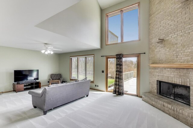23883 W Sarah Ct, Antioch, IL 60002 - living area with carpet, a brick fireplace, a ceiling fan, and a high ceiling