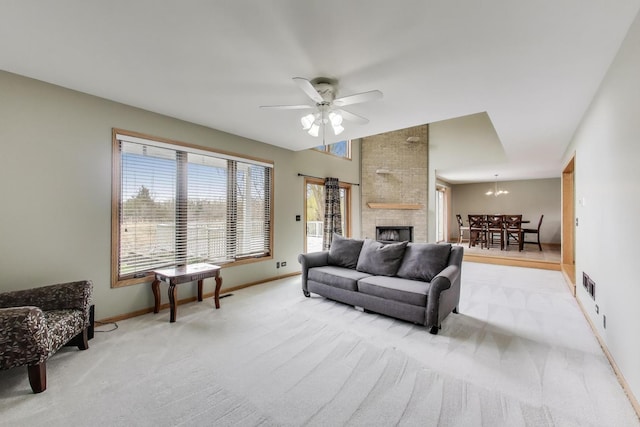 23883 W Sarah Ct, Antioch, IL 60002 - living area with baseboards, light carpet, a large fireplace, a ceiling fan, and a chandelier
