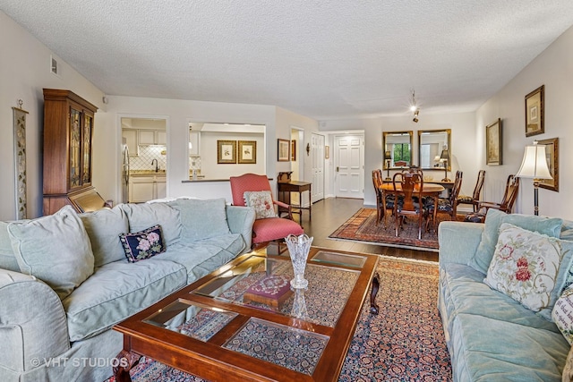 702 Waukegan Rd Unit A207, Glenview, IL 60025 - living room featuring wood finished floors and a textured ceiling