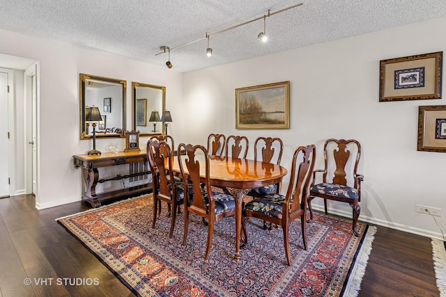 702 Waukegan Rd Unit A207, Glenview, IL 60025 - dining space featuring wood finished floors, a textured ceiling, and baseboards