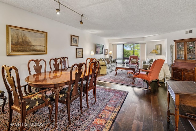 702 Waukegan Rd Unit A207, Glenview, IL 60025 - dining area with a textured ceiling and hardwood / wood-style floors