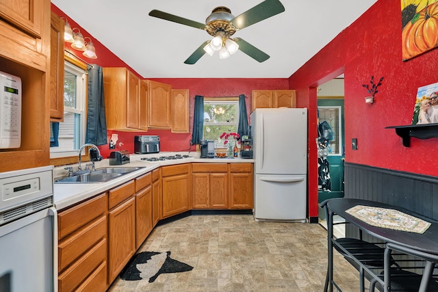 341 N Center St, Braidwood, IL 60408 - kitchen featuring white appliances, a sink, a ceiling fan, stone finish floors, and light countertops