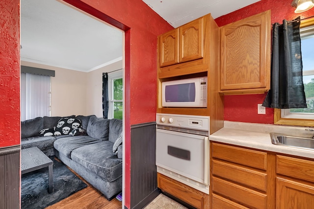 341 N Center St, Braidwood, IL 60408 - kitchen featuring white appliances, open floor plan, light countertops, light wood finished floors, and a sink