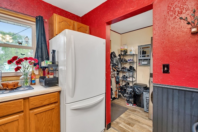 341 N Center St, Braidwood, IL 60408 - kitchen featuring freestanding refrigerator, light wood-style floors, and light countertops