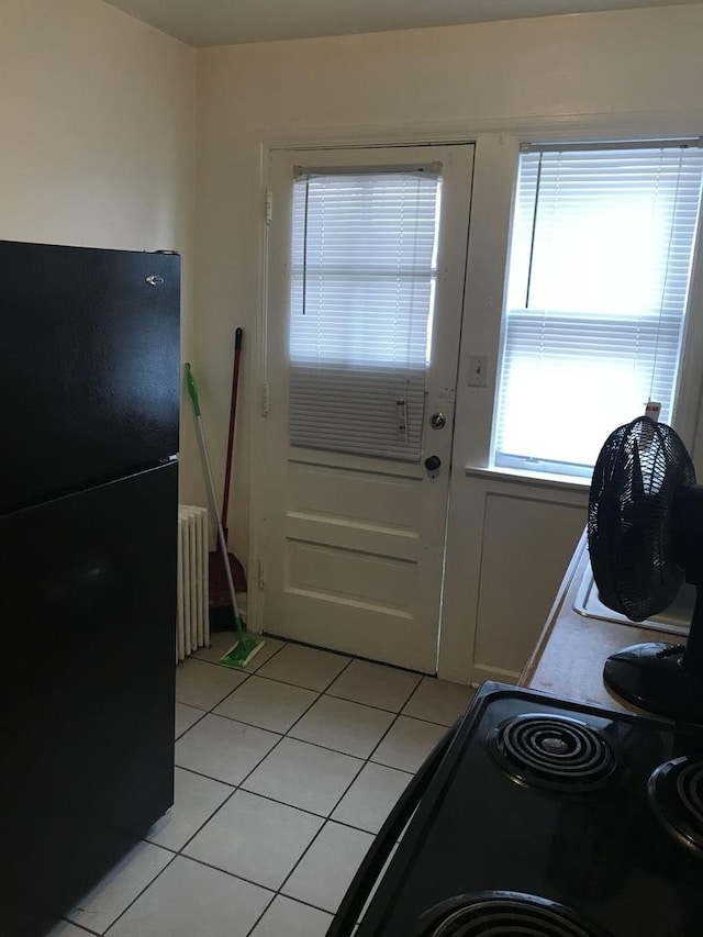 802 Bellwood Ave Unit 2S, Bellwood, IL 60104 - doorway featuring radiator and light tile patterned floors
