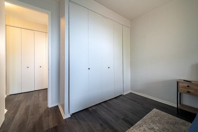 3021 S Michigan Ave Unit 102, Chicago, IL 60616 - unfurnished bedroom featuring dark wood finished floors, baseboards, and a closet