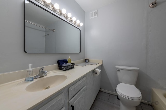 3021 S Michigan Ave Unit 102, Chicago, IL 60616 - bathroom with toilet, vanity, a tub to relax in, tile patterned floors, and baseboards