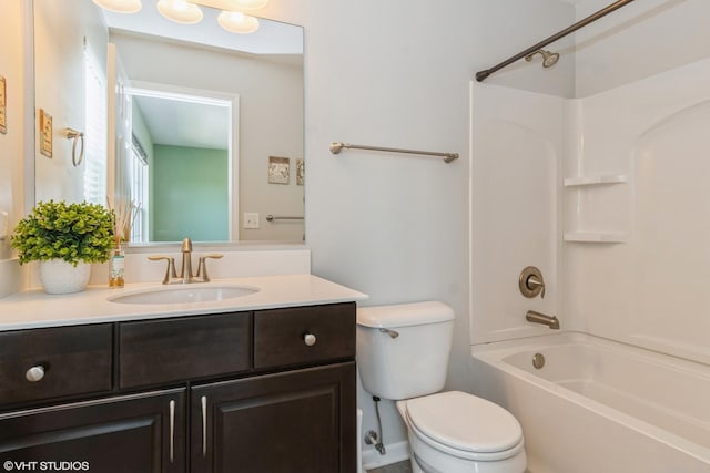 bathroom with toilet, vanity, and shower / tub combination