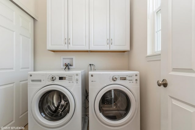 laundry room with independent washer and dryer and cabinet space