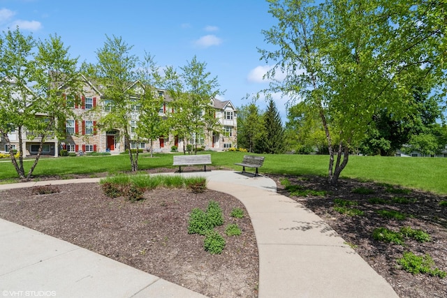 view of property's community with a lawn