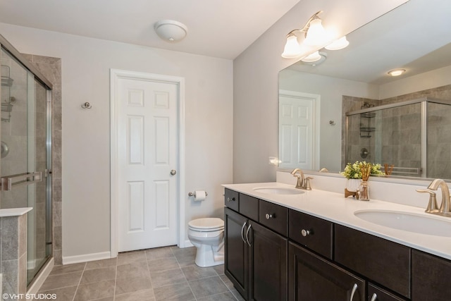 bathroom with a stall shower, double vanity, tile patterned flooring, and toilet