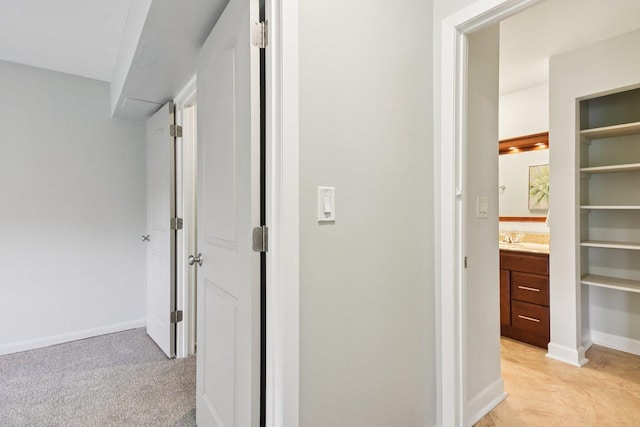 493 Mchenry Rd Unit 1B, Wheeling, IL 60090 - hall featuring a sink, baseboards, and light colored carpet