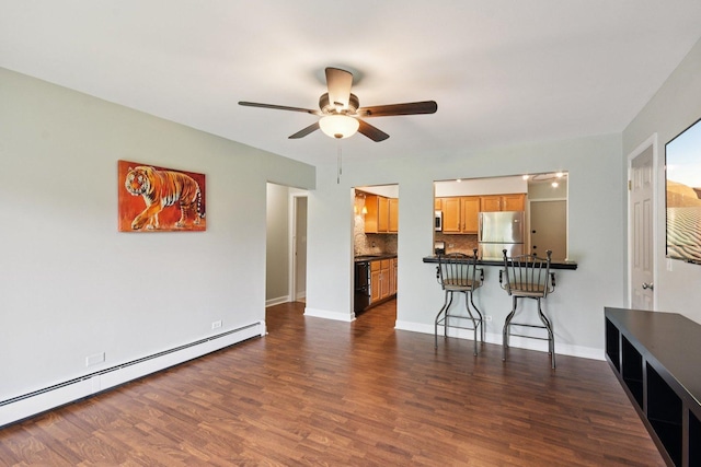 493 Mchenry Rd Unit 1B, Wheeling, IL 60090 - kitchen with baseboard heating, freestanding refrigerator, a breakfast bar, ceiling fan, and dark wood finished floors