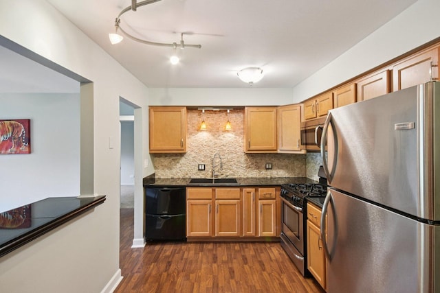 493 Mchenry Rd Unit 1B, Wheeling, IL 60090 - kitchen featuring stainless steel appliances, a sink, dark countertops, decorative backsplash, and dark wood finished floors
