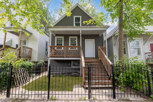 907 W 50th St, Chicago, IL 60609 - view of front of home featuring a porch, a fenced front yard, stairs, and a gate