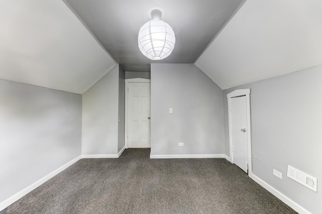907 W 50th St, Chicago, IL 60609 - bonus room featuring vaulted ceiling, dark colored carpet, and baseboards