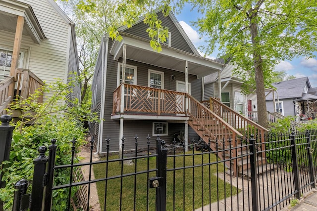 907 W 50th St, Chicago, IL 60609 - view of front of property featuring a porch, a fenced backyard, stairway, and a gate
