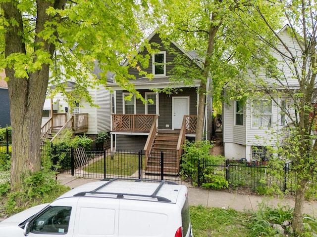 907 W 50th St, Chicago, IL 60609 - view of front facade featuring stairs, covered porch, a fenced front yard, and a gate