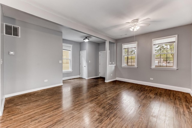 907 W 50th St, Chicago, IL 60609 - unfurnished living room featuring a ceiling fan, baseboards, and dark wood-style flooring