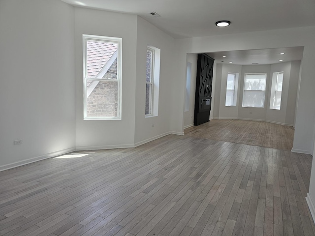 4336 W Gladys Ave, Chicago, IL 60624 - spare room featuring light wood-style flooring, healthy amount of natural light, and baseboards