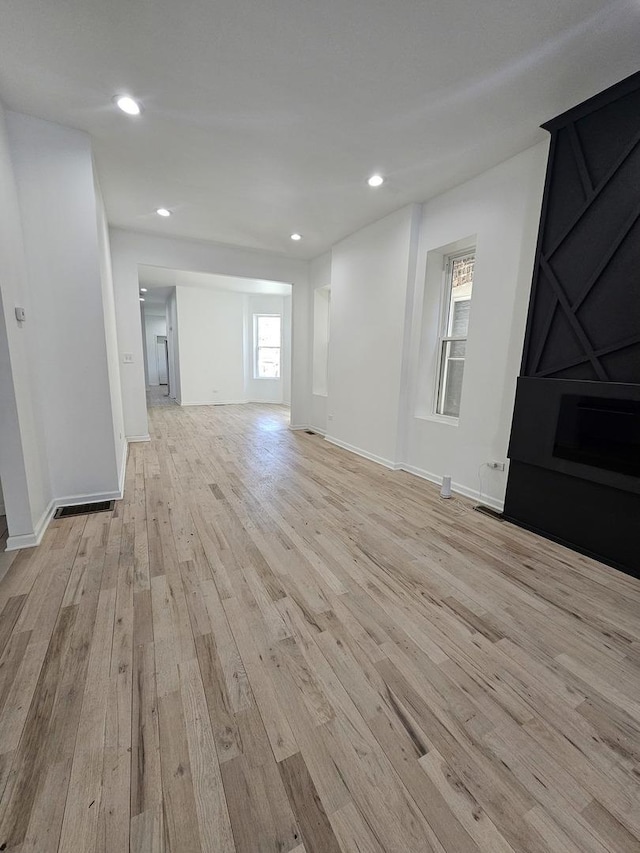4336 W Gladys Ave, Chicago, IL 60624 - unfurnished living room with light wood-style flooring, recessed lighting, and baseboards