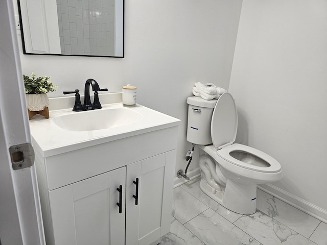 4336 W Gladys Ave, Chicago, IL 60624 - bathroom with baseboards, marble look tile flooring, toilet, and vanity