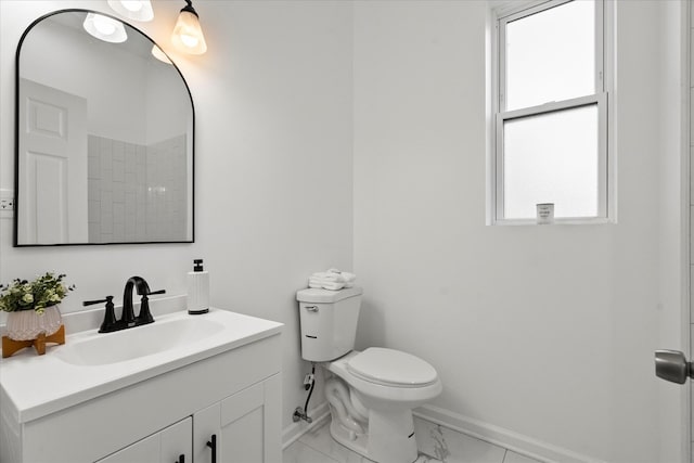 4336 W Gladys Ave, Chicago, IL 60624 - bathroom with baseboards, marble finish flooring, toilet, and vanity