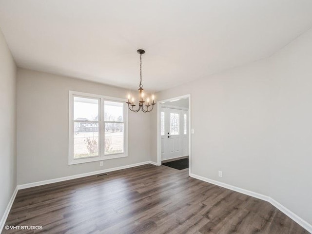 35491 N Kenneth Dr, Lake Villa, IL 60046 - unfurnished dining area featuring a chandelier, dark wood finished floors, and baseboards