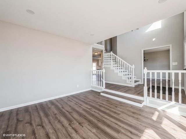 35491 N Kenneth Dr, Lake Villa, IL 60046 - unfurnished living room featuring wood finished floors, baseboards, and stairway