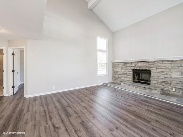 35491 N Kenneth Dr, Lake Villa, IL 60046 - unfurnished living room with high vaulted ceiling, wood finished floors, a stone fireplace, and baseboards
