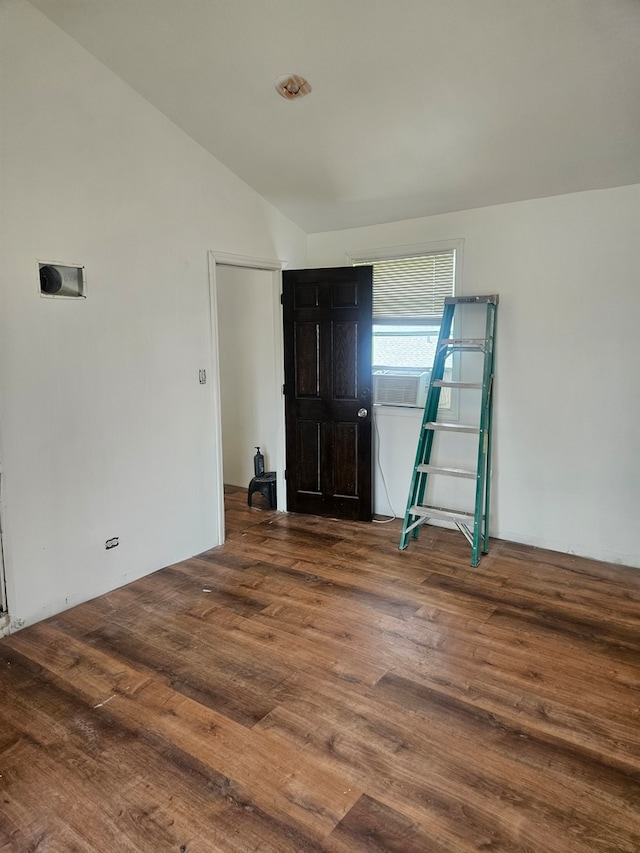 spare room with lofted ceiling and wood finished floors