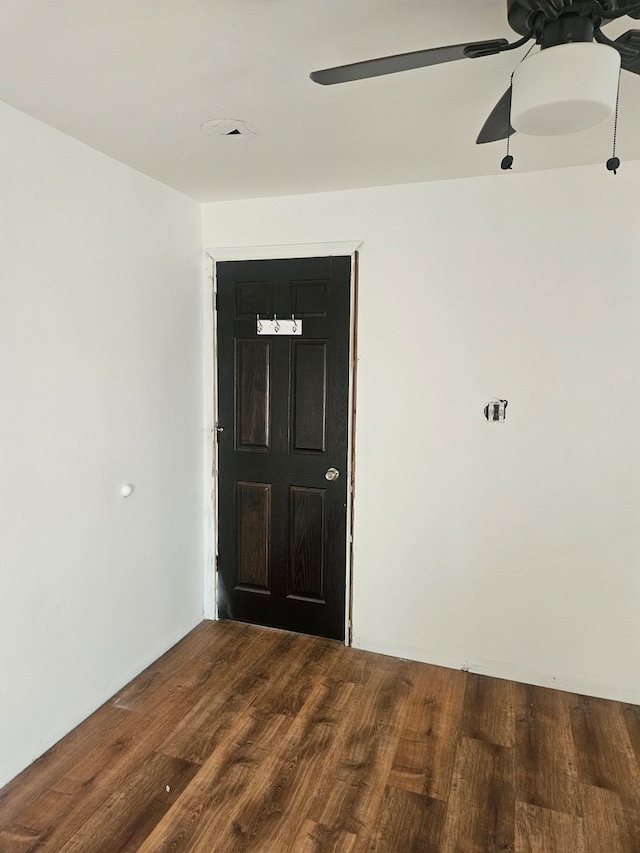 unfurnished room featuring wood finished floors and a ceiling fan