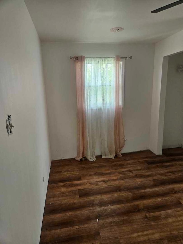spare room featuring dark wood finished floors