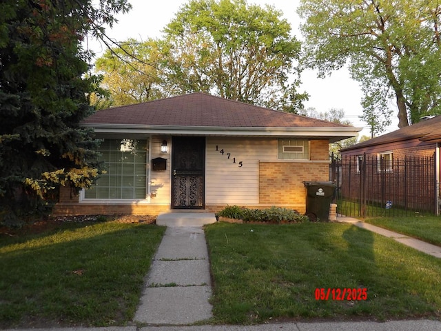 14715 Kenwood Ave, Dolton, IL 60419 - ranch-style house with a front lawn and brick siding