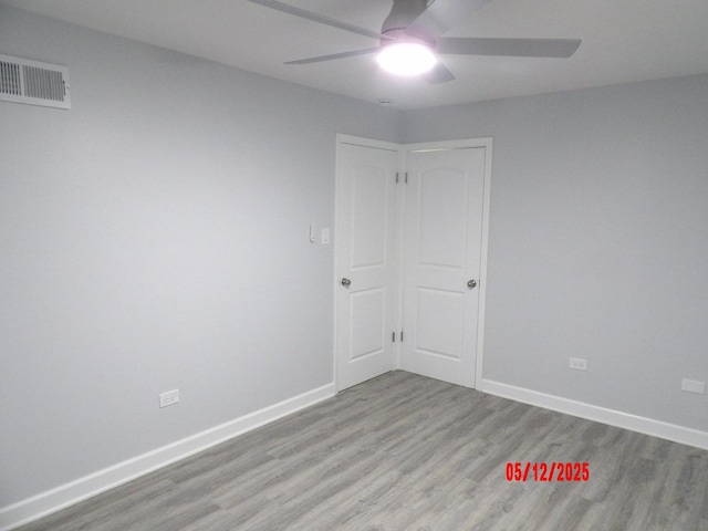14715 Kenwood Ave, Dolton, IL 60419 - unfurnished room featuring a ceiling fan, wood finished floors, and baseboards