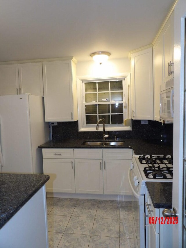 14715 Kenwood Ave, Dolton, IL 60419 - kitchen with a sink, white appliances, white cabinetry, and tasteful backsplash